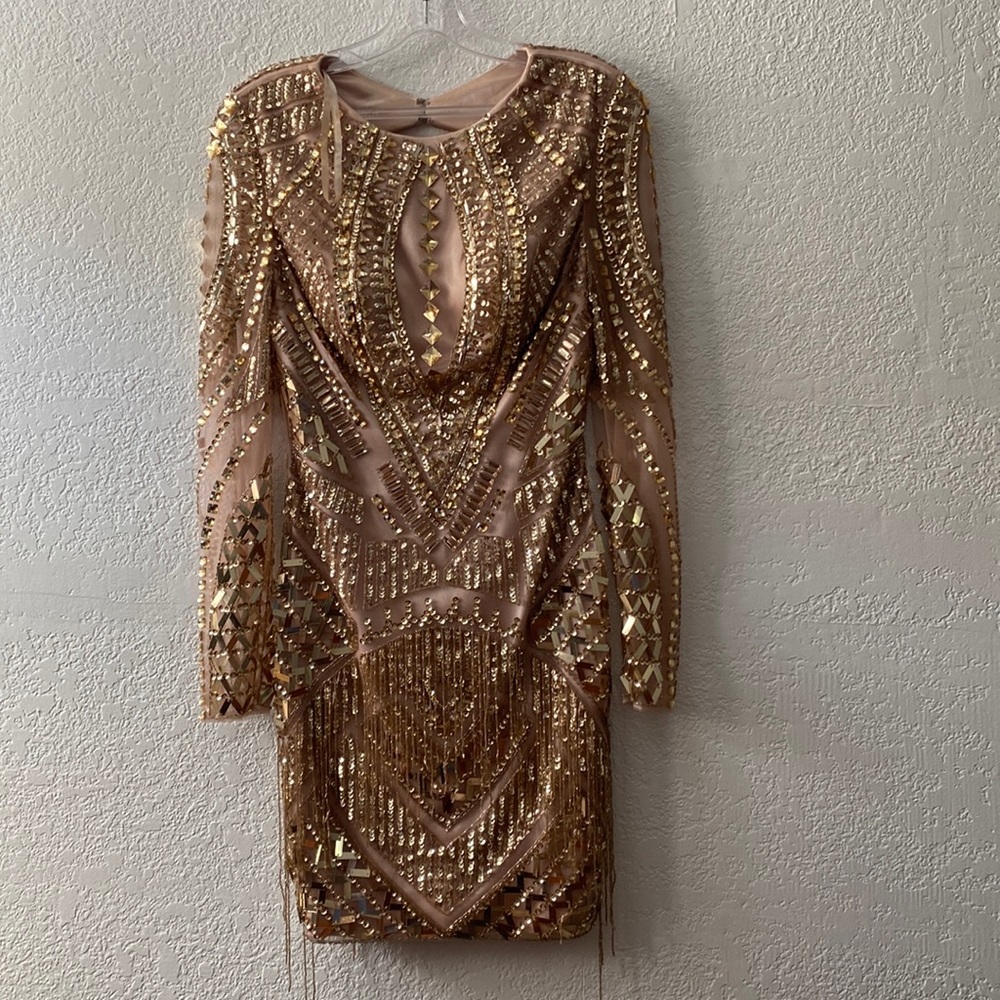 Rose gold. Short dress. Really detailed with tons of rhinestones. Fun fringes.
